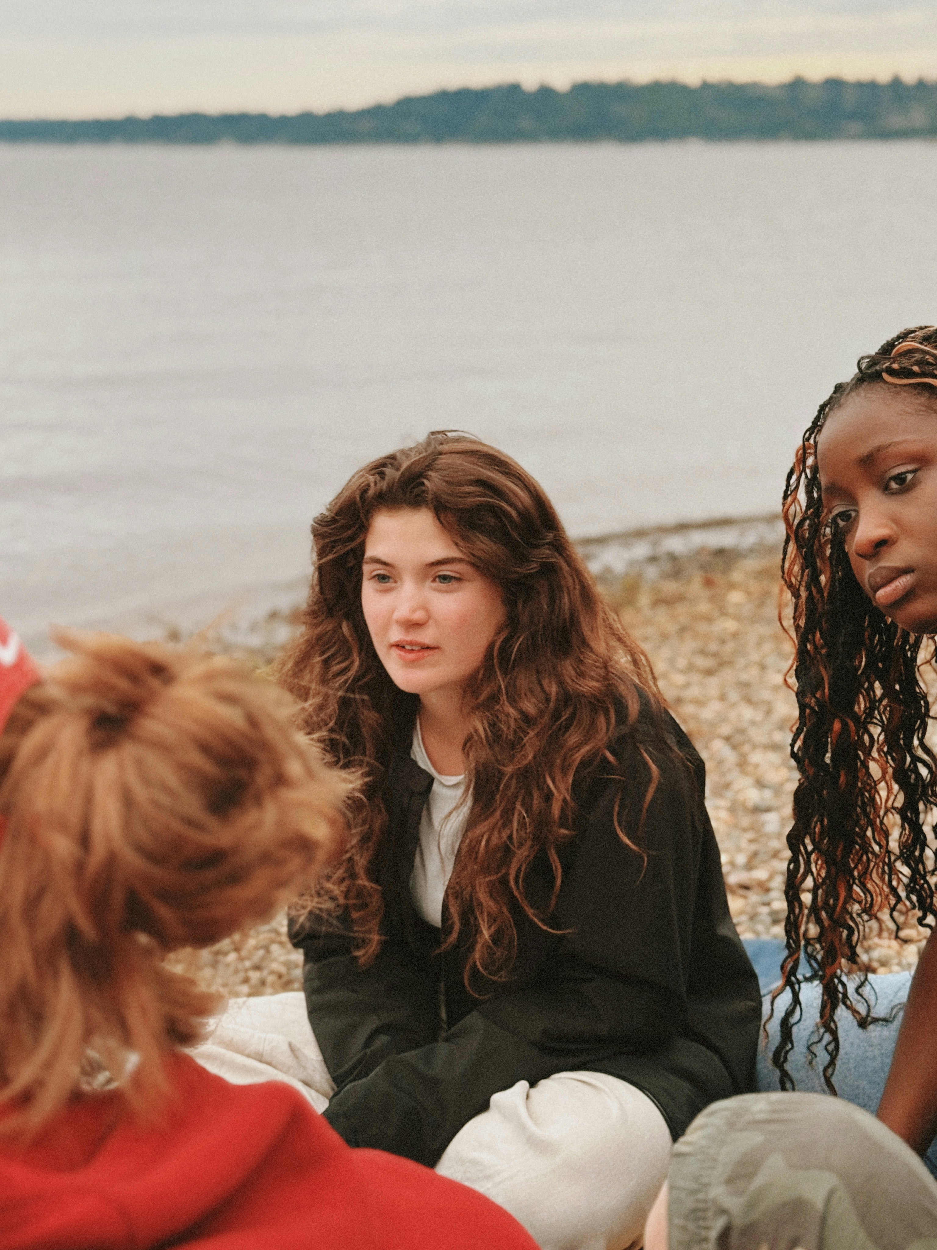 Five teenage girls pulling playful faces and hand signs on a staircase